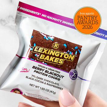 Lexington Bakes Berry Blackout protein cookie in packaging, held in hand