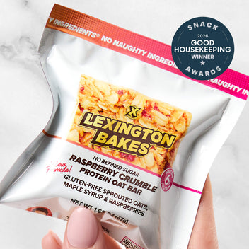 Lexington Bakes raspberry crumble protein oat bar in packaging, held in hand